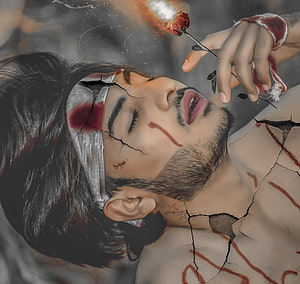 Injured man with bandaged head and cracked skin holding a burning red rose in a dramatic artistic style, Alone Sad Broken Heart Boy Crying, Broken Couple HD wallpaper