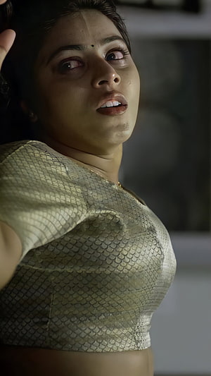 Poorna Kasim in a shimmering sequined blouse with dramatic low-key lighting HD phone wallpaper