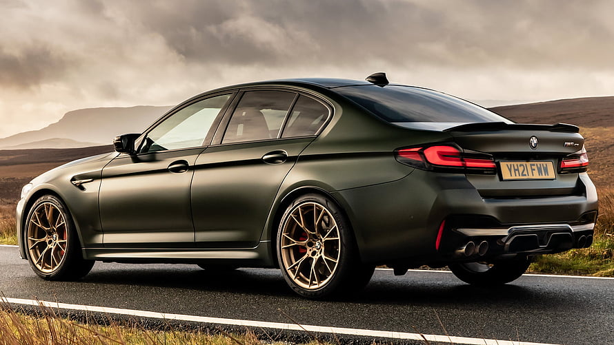 Matte Green BMW M5 Competition with Bronze Wheels on a Scenic Road HD wallpaper