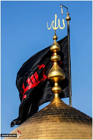 Golden Dome of Imam Husayn Shrine in Karbala with Black Flag Against Blue Sky HD phone wallpaper