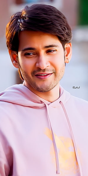 Mahesh Babu in a soft pink hoodie with a warm smile and styled dark hair HD phone wallpaper