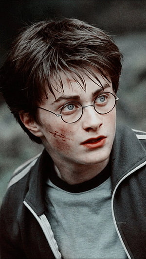 Daniel Radcliffe as Harry Potter in a close-up portrait with round glasses and a grey jacket HD phone wallpaper