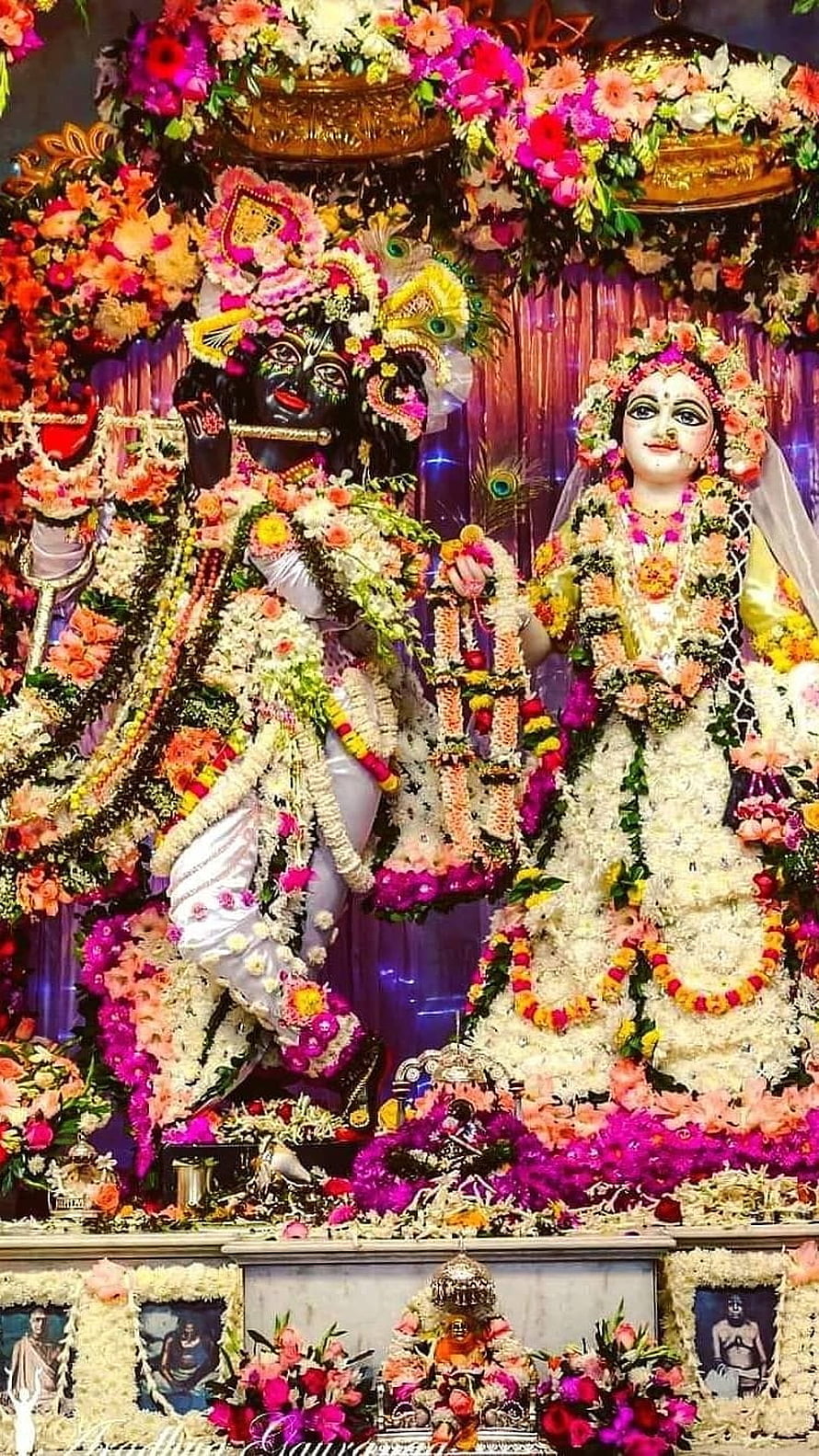 Radha Krishna Deities Adorned in Vibrant Floral Garlands and Jewels HD phone wallpaper