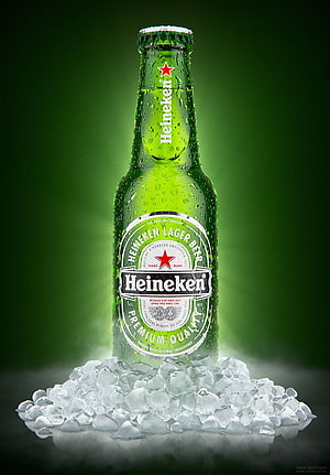 Chilled Heineken Lager Beer Bottle with Ice and Condensation on Green Background HD phone wallpaper