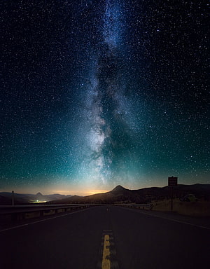 Milky Way Galaxy Arching Over a Desert Highway at Night HD phone wallpaper