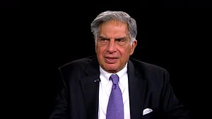 Ratan Tata in a dark suit and purple tie against a black background HD wallpaper
