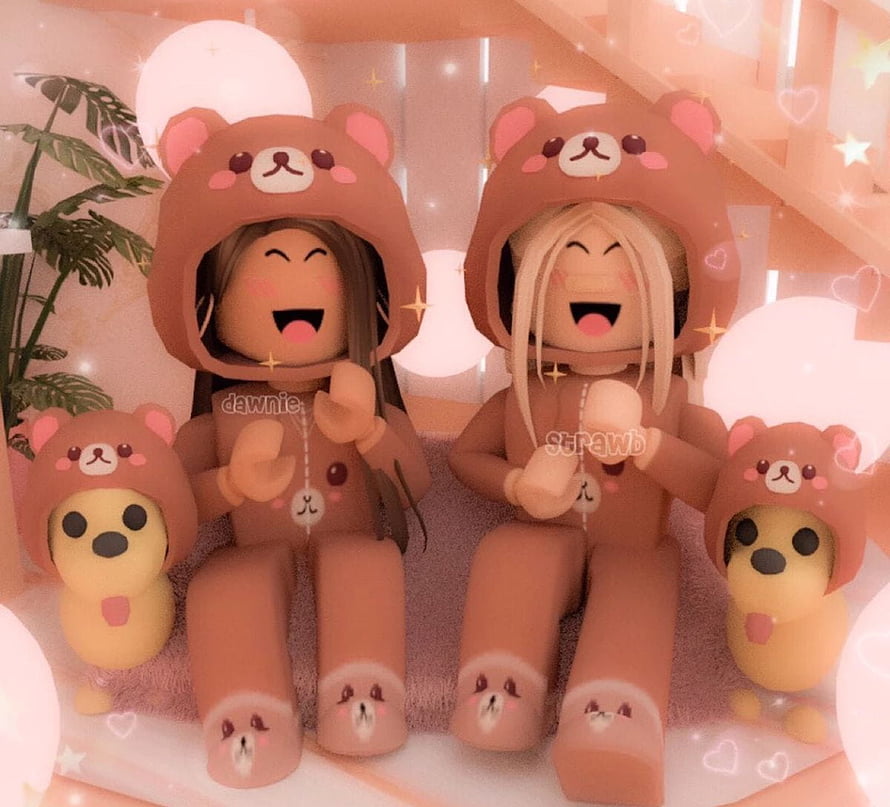 Cute Roblox avatars in matching brown bear hoodies sitting with plush toys in a cozy pink room HD wallpaper