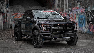 Black Ford F-150 Raptor Pickup Truck Parked in Urban Graffiti Tunnel HD wallpaper