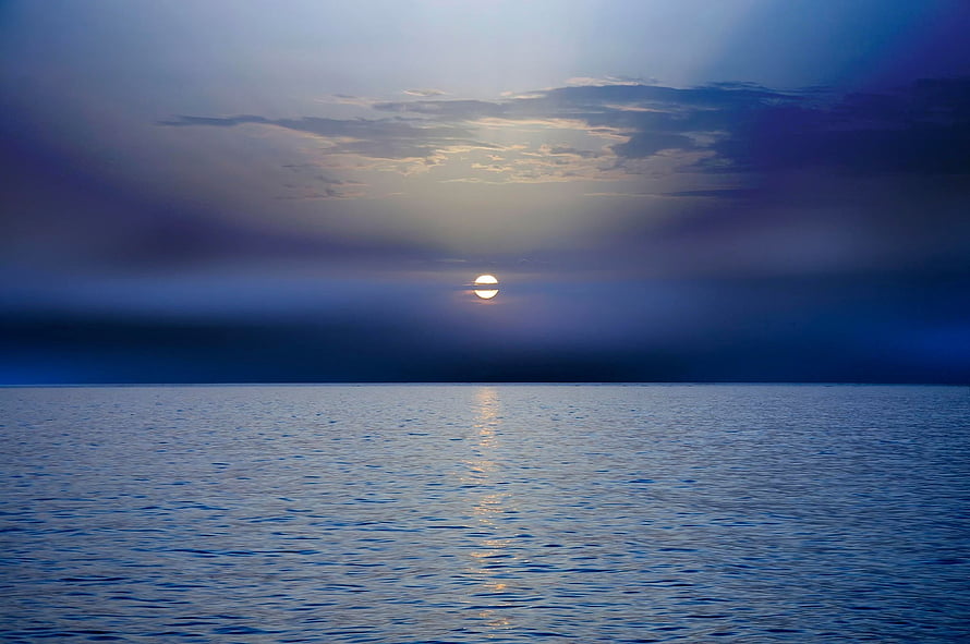 Serene Sunset Over Calm Ocean With Golden Sun Reflection And Blue Sky HD wallpaper