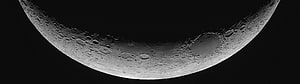 Crescent Moon Cratered Surface Against Deep Black Space HD wallpaper