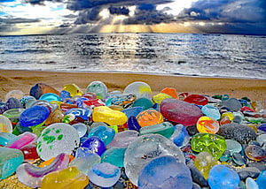 Colorful Sea Glass Stones on Sandy Beach with Ocean Sunset Background HD wallpaper