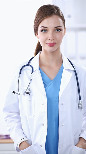 Portrait of a female doctor in a white coat and blue scrubs with a stethoscope HD phone wallpaper