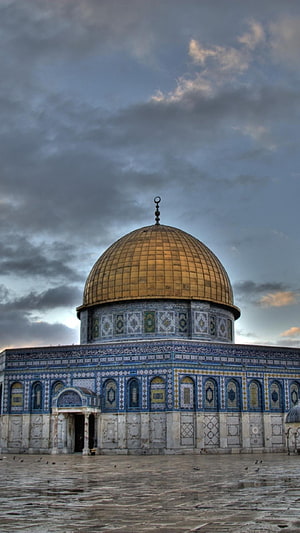 Dome of the Rock in Jerusalem with golden dome and intricate tilework under a dramatic cloudy sky HD phone wallpaper