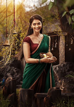 Pooja Hegde in Green Saree Holding Coconut and Flowers in Temple Setting HD phone wallpaper