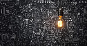 Glowing Light Bulb Against Chalkboard Business Strategy Diagrams HD wallpaper