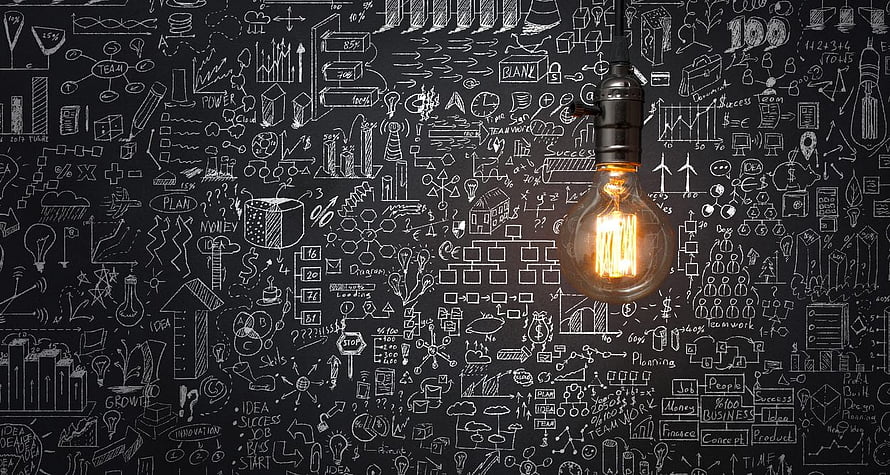 Glowing Light Bulb Against Chalkboard Business Strategy Diagrams HD wallpaper