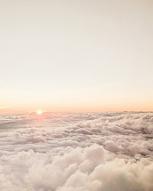Sunrise Above the Clouds: A Serene Pastel Sky and Fluffy White Cloudscape HD phone wallpaper