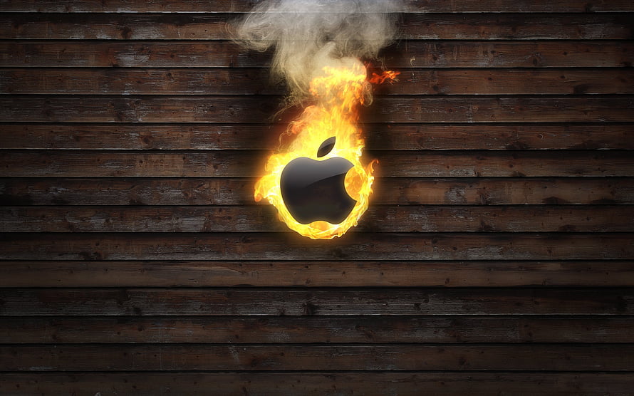 Apple Logo Enveloped in Flames Against Dark Rustic Wooden Plank Background HD wallpaper