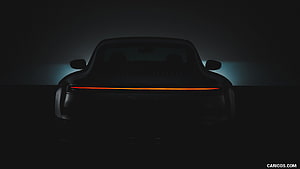 Porsche 911 Carrera 4S Rear View With Glowing Amber Tail Light Strip In Dark Studio Setting HD wallpaper
