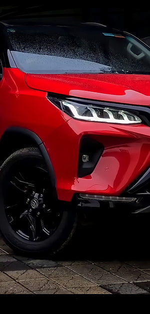 Close-up of a Red Toyota RAV4 Front Headlight and Black Alloy Wheel HD phone wallpaper