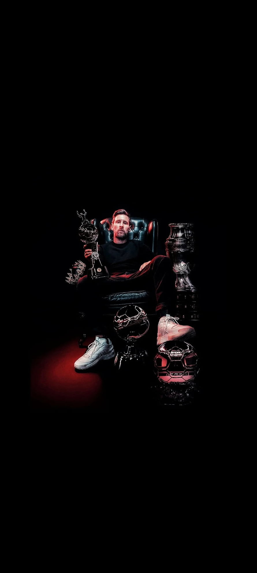 Lionel Messi Seated in a Dark Room Surrounded by Ballon d'Or Trophies and Soccer Balls HD phone wallpaper
