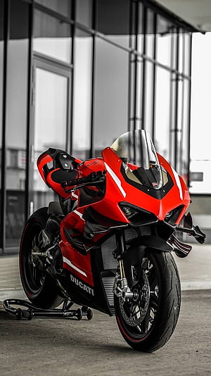 Red Ducati Panigale V4 Superleggera Superbike Parked in Modern Urban Setting HD phone wallpaper