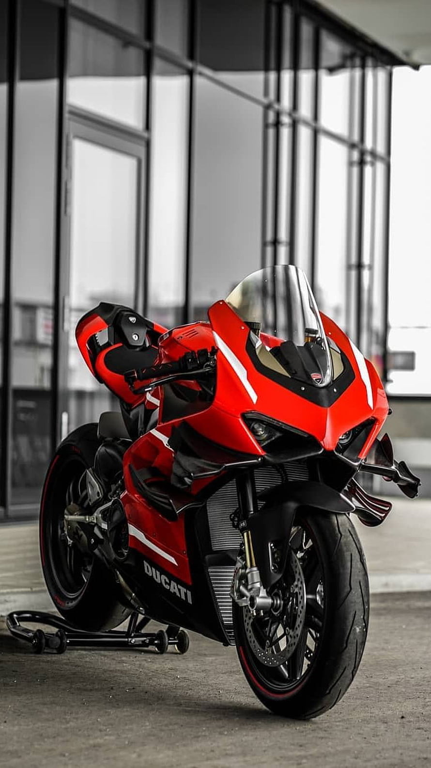 Red Ducati Panigale V4 Superleggera Superbike Parked in Modern Urban Setting HD phone wallpaper