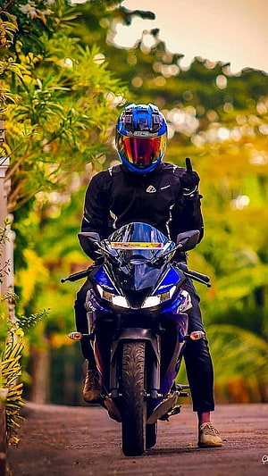 Biker on Blue Sport Motorcycle Giving Thumbs Up on Scenic Road HD phone wallpaper