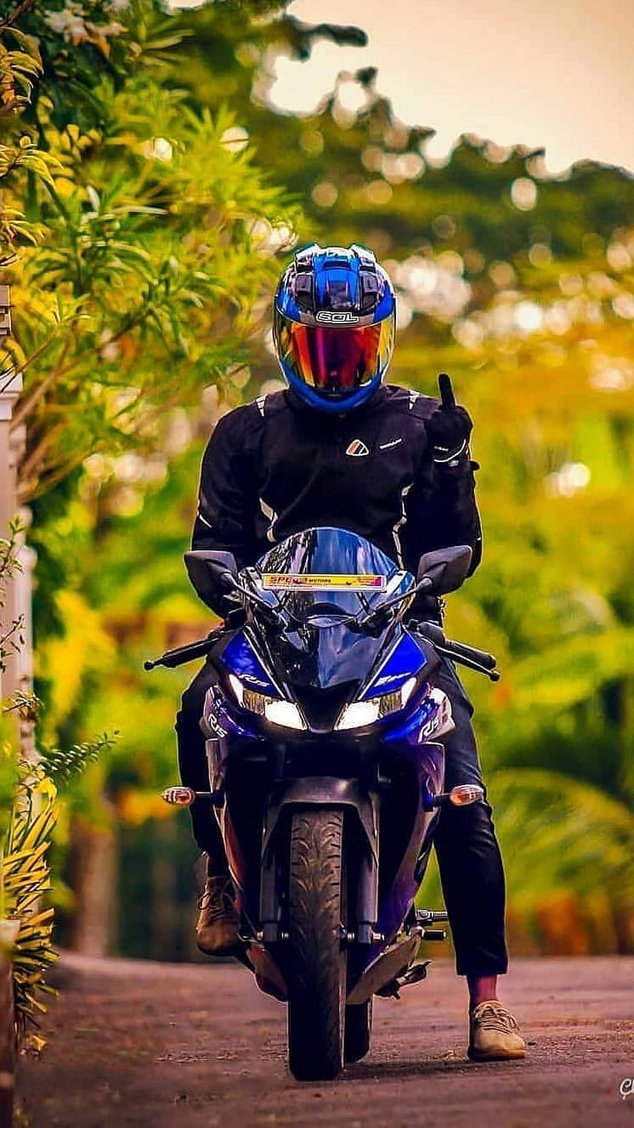 Biker on Blue Sport Motorcycle Giving Thumbs Up on Scenic Road HD phone wallpaper