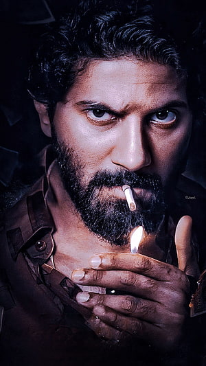 Dulquer Salmaan Intense Close-Up Portrait Lighting a Cigarette in Dark Cinematic Style HD phone wallpaper
