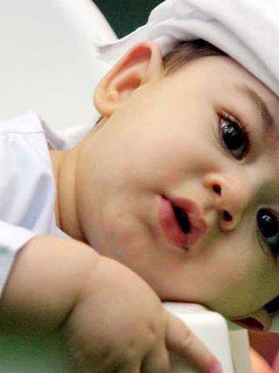 Adorable Muslim Baby Boy Wearing Traditional White Cap and Outfit HD phone wallpaper