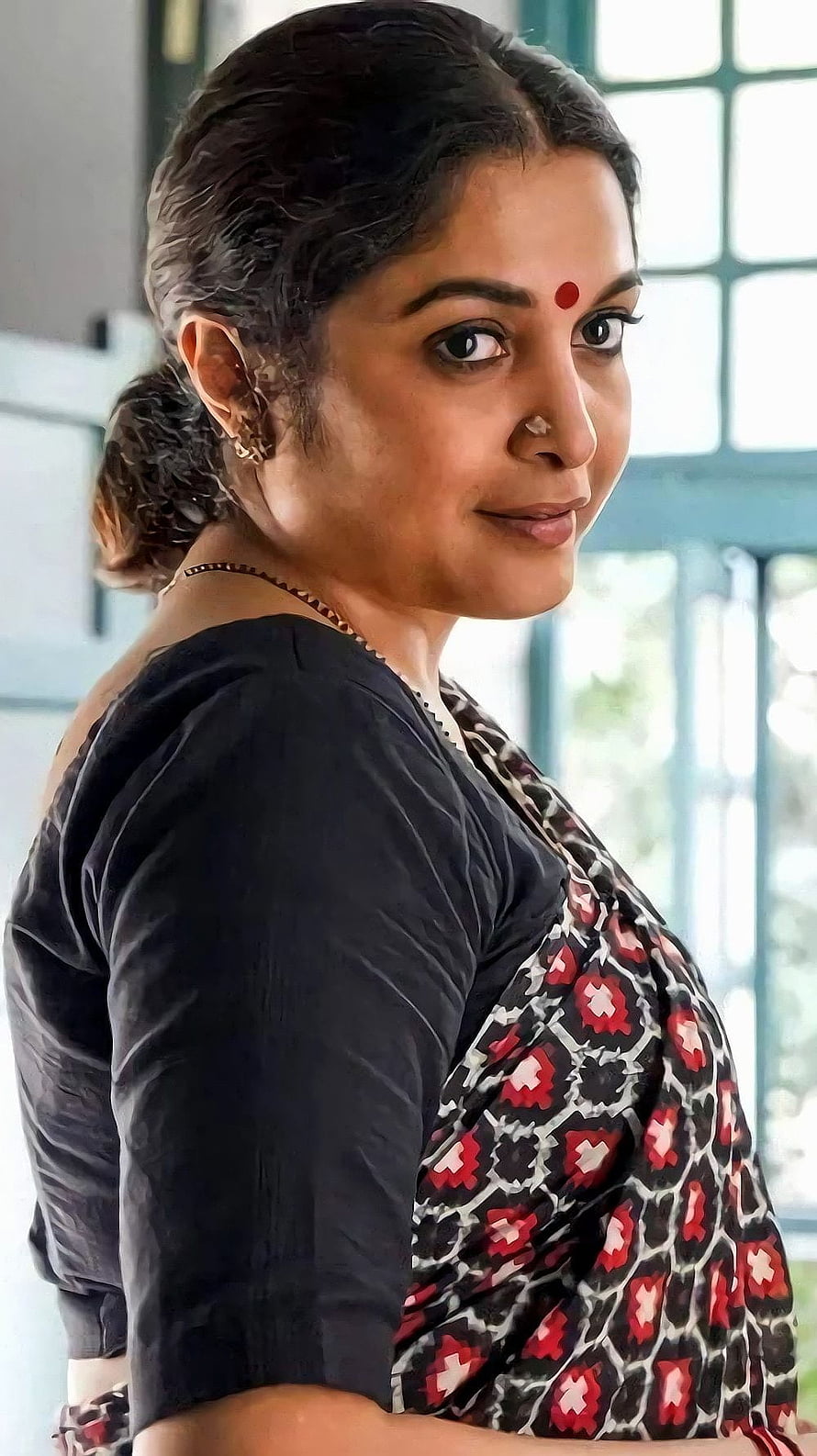 Ramya Krishnan in a black blouse and patterned saree with a red bindi HD phone wallpaper