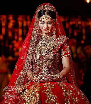 Elegant Indian Bride in Red Lehenga with Heavy Gold Jewelry and Henna HD phone wallpaper