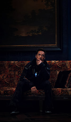 Tony Stark Sitting on Sofa in Dark Room with Arc Reactor Glowing HD phone wallpaper