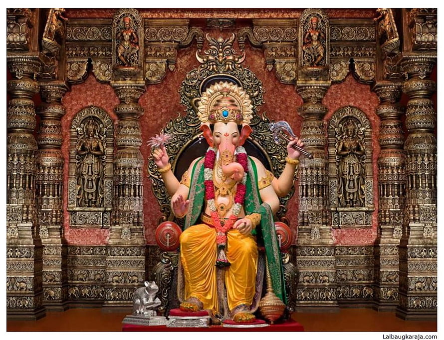 Lord Ganesha Statue in Ornate Temple Shrine with Intricate Carvings HD wallpaper