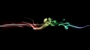 Vibrant multicolored smoke swirls flowing across a dark background with red, yellow, and green light trails HD wallpaper