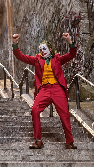 Joker Arthur Fleck Dancing on Stairs in Red Suit from the 2019 Movie HD phone wallpaper