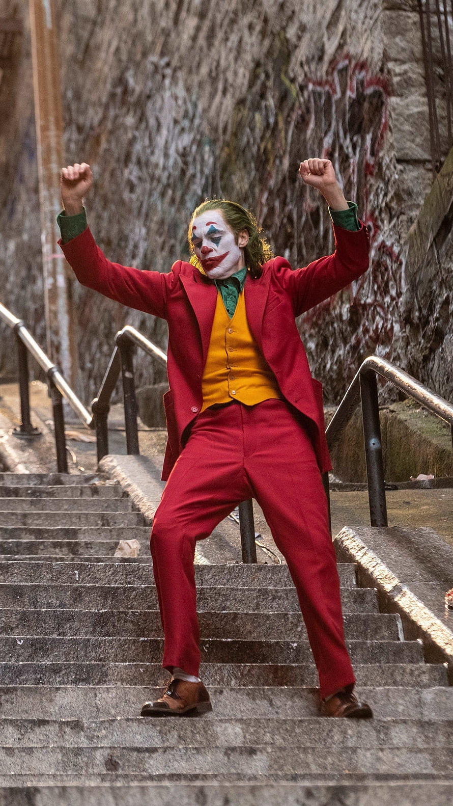 Joker Arthur Fleck Dancing on Stairs in Red Suit from the 2019 Movie HD phone wallpaper