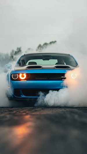 Blue Dodge Challenger SRT Performing a Smoky Burnout on Wet Asphalt HD phone wallpaper
