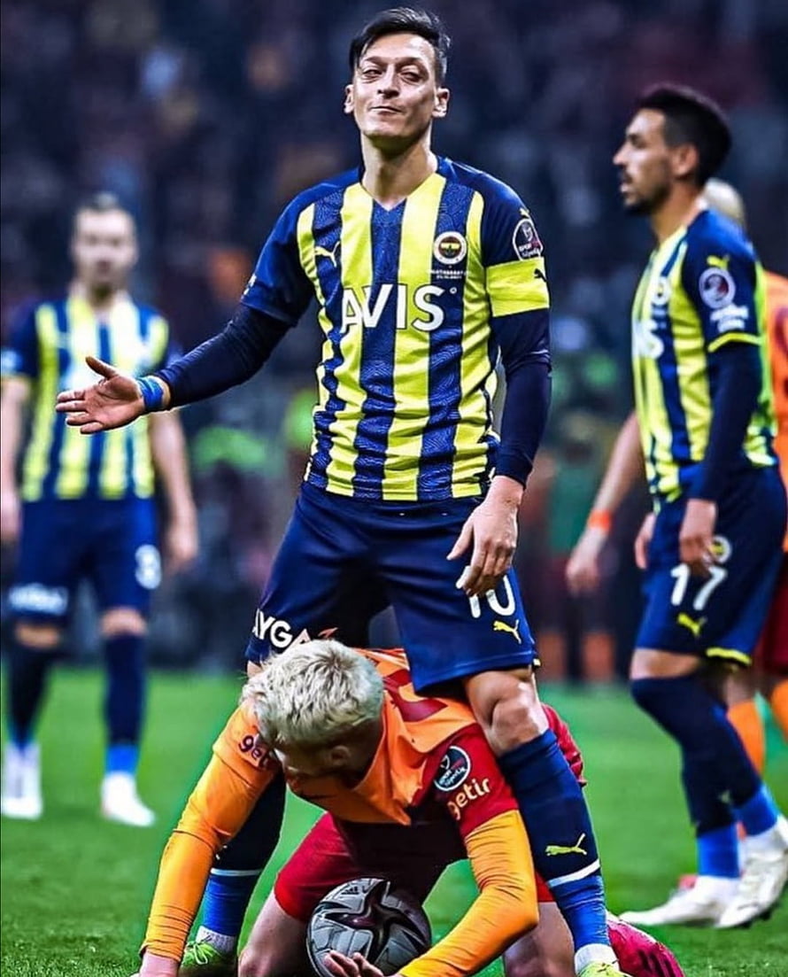 Fenerbahce Player in Blue and Yellow Striped Kit During Intense Soccer Match HD phone wallpaper