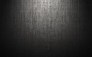 Dark brushed metal texture with vertical grain and soft central spotlight HD wallpaper