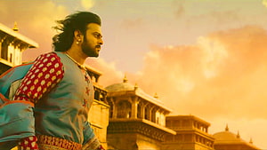 Prabhas as Baahubali in traditional attire against a golden palace backdrop HD wallpaper