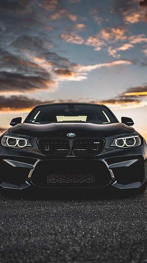 Black BMW M2 Competition Front View at Sunset with Dramatic Clouds HD phone wallpaper