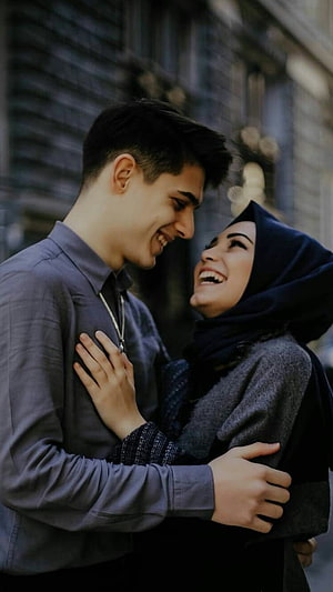 Happy Muslim Couple Laughing Together in Urban Street Setting HD phone wallpaper