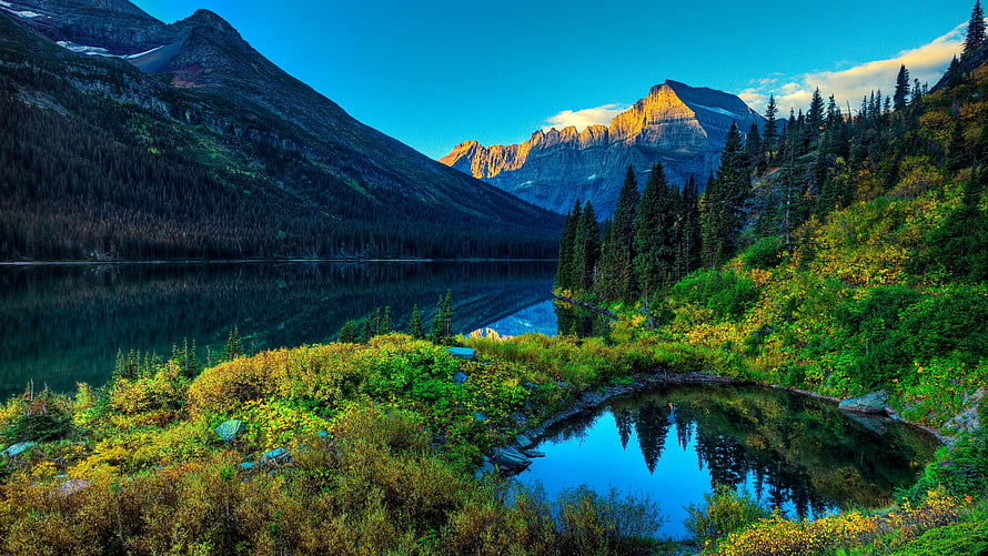Majestic Mountain Lake Reflections in Spring with Lush Greenery and Golden Peaks HD wallpaper