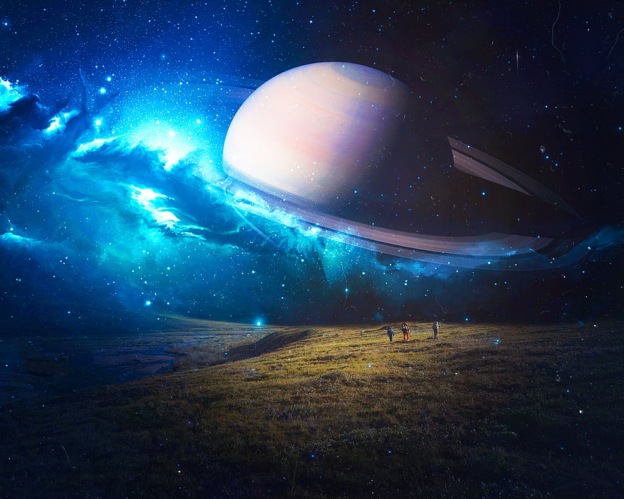 Astronauts standing on a grassy alien planet surface gazing at a massive ringed gas giant and glowing blue nebula in deep space HD wallpaper