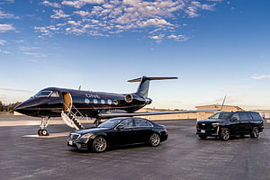 Luxury Private Jet and Black Cars on Airport Tarmac HD wallpaper