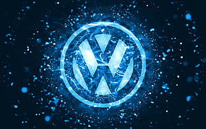 Volkswagen emblem glowing with electric blue energy and particle effects on a dark background HD wallpaper