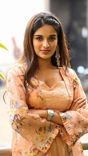 Nidhi Agarwal in a peach floral kurta with gold jhumka earrings and a wristwatch HD phone wallpaper