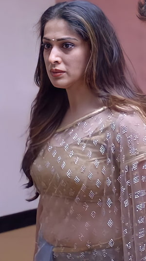 Lakshmi Rai in a shimmering gold sequined saree with long wavy hair and a serious expression HD phone wallpaper